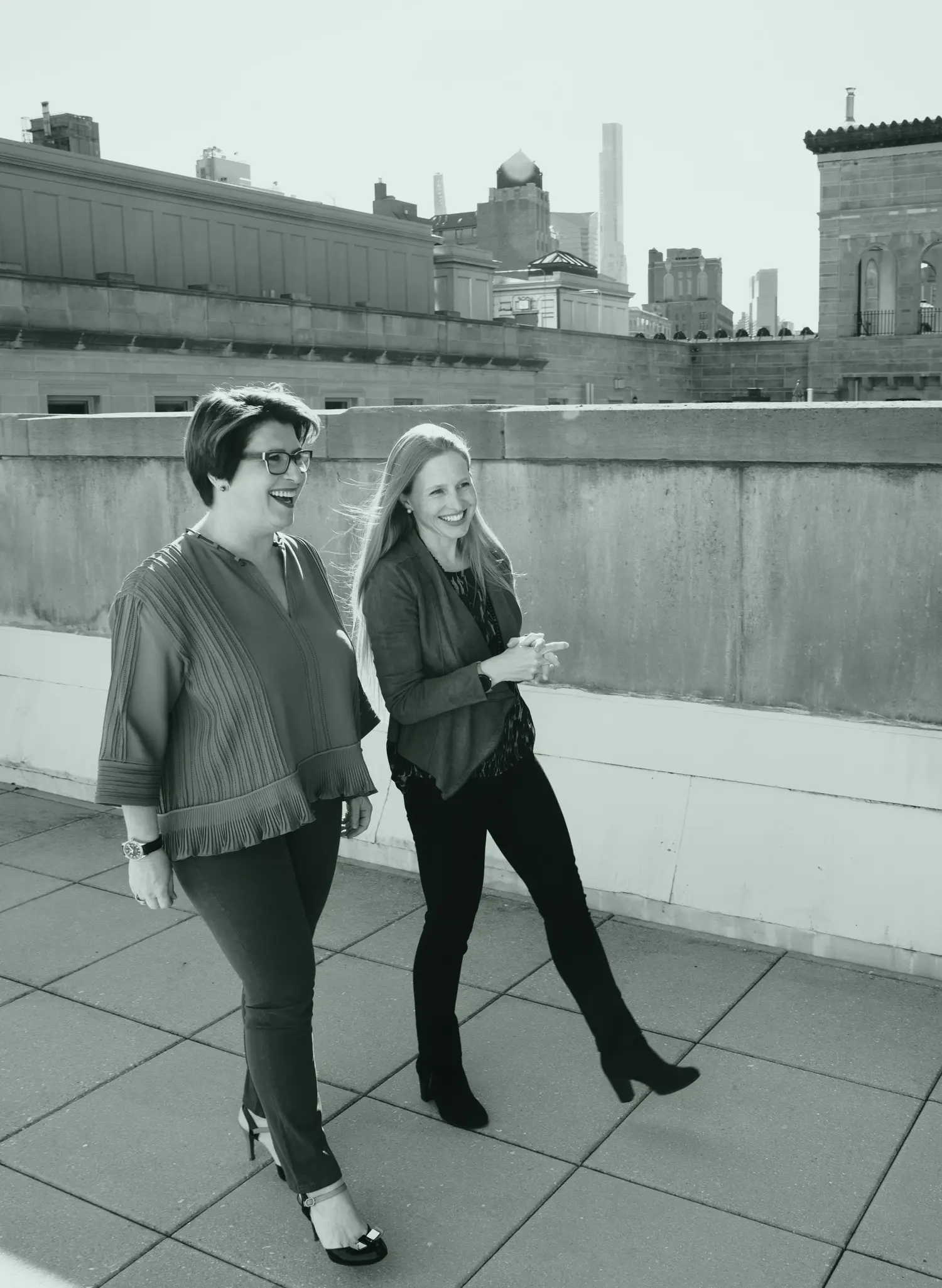 Molly and Véronique walking on a rooftop